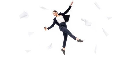 panoramic shot of businesswoman holding paper cup while levitating surrounded with flying papers...
