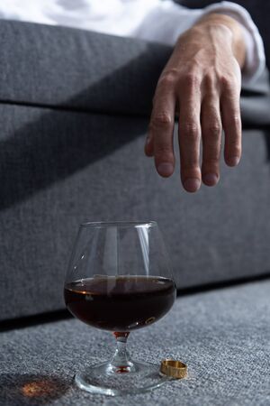partial view of man with ring and glass of cognacの写真素材