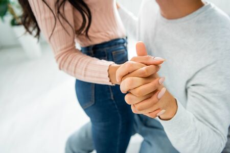 cropped view of african american woman and man holding hands
