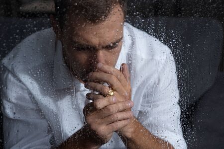 selective focus of upset man with ring at homeの写真素材