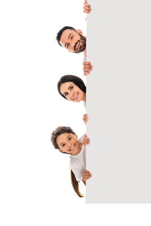 happy kid and cheerful parents holding placard isolated on whiteの写真素材