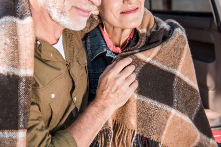 cropped view of senior couple sitting in car with blanketの写真素材