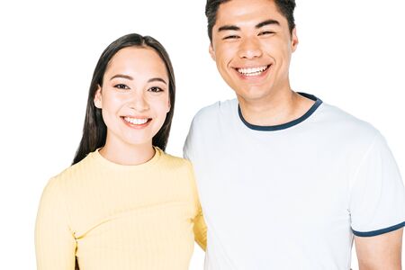 happy asian man and woman smiling while looking at camera isolated on white