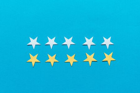 top view of white and yellow stars isolated on blueの写真素材