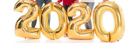 panoramic shot of parents and kid standing near air balloons isolated on white