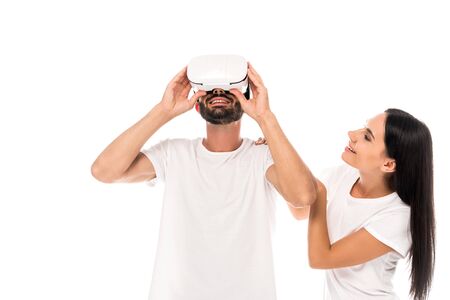happy woman looking at bearded man using virtual reality headset isolated on whiteの写真素材
