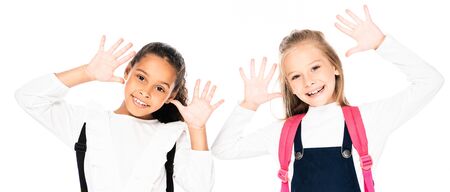 panoramic shot of two cheerful multicultural schoolgirls showing chalk stained hands  isolated on...