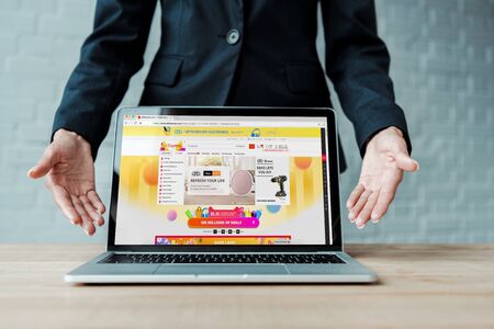 KYIV, UKRAINE - AUGUST 5, 2019: cropped view of woman gesturing near laptop with aliexpress website...