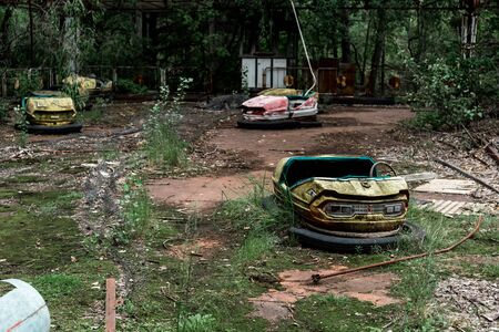 selective focus of abandoned bumper cars in amusement park
