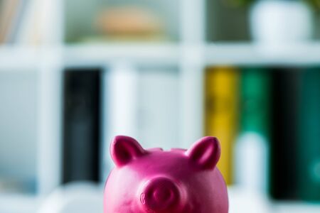 toy and pink piggy bank in modern officeの写真素材