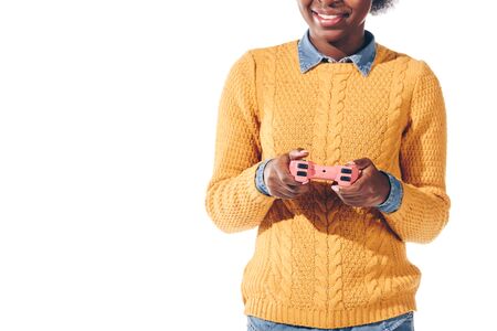 cropped view of african american girl playing video game with joystick, isolated on white