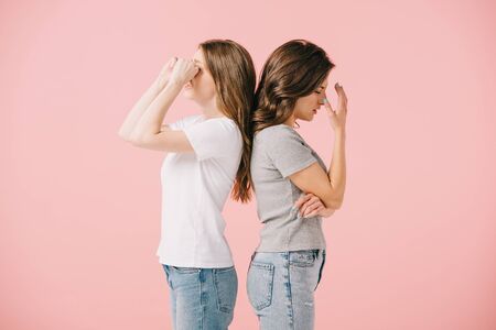 side view of sad women in t-shirts isolated on pinkの写真素材