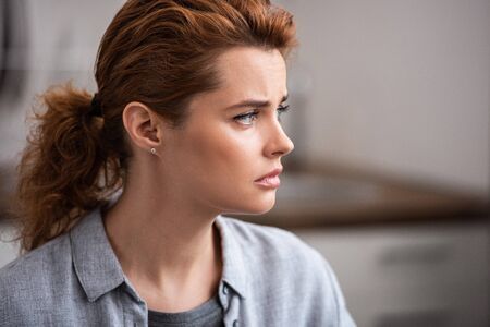 attractive and upset woman with bad mood at home