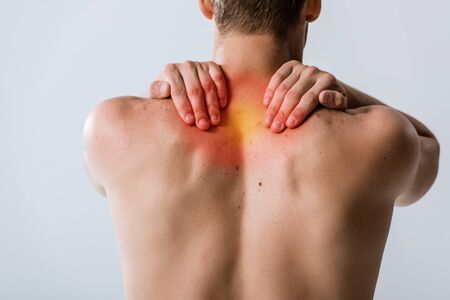 cropped view of shirtless man with neck pain isolated on grey