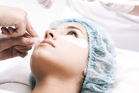 model in hair cap looking at eyelash masterの写真素材