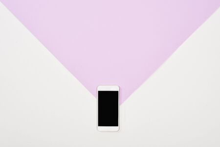 top view  of smartphone with blank screen on violet and white backgroundの写真素材
