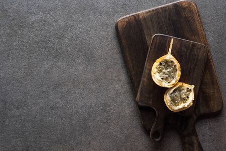 top view of sweet granadilla on wooden cutting boards on grey backgroundの写真素材