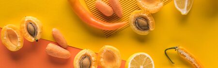 top view of yellow fruits and vegetables on orange background, panoramic shot
