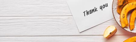 top view of thank you card on wooden white table with apples and pumpkin, panoramic shot