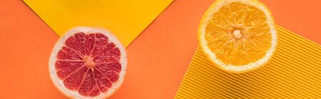 top view of grapefruit and orange on yellow background, panoramic shotの写真素材
