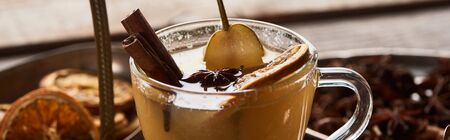 close up view of delicious pear mulled wine with spices and dried citrus, panoramic shotの写真素材