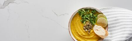 panoramic shot of tasty mashed pumpkin soup on marble surfaceの写真素材