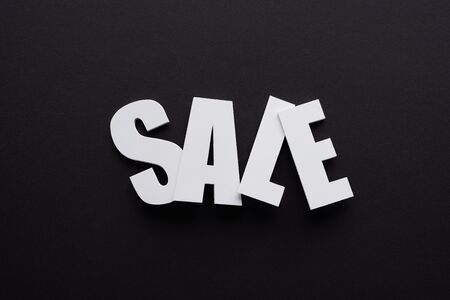 top view of white sale lettering on black background