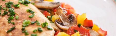 close up of yummy wrapped omelet with vegetables on plateの写真素材