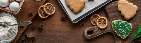 top view of Christmas cookies and  ingredients on wooden table, panoramic shotの写真素材