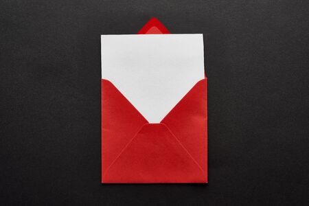 top view of blank card in red envelope on black backgroundの写真素材