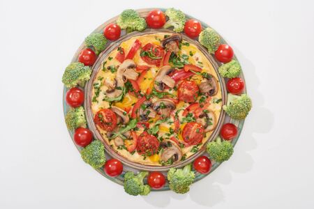 top view of homemade omelet on plate with fresh tomatoes and broccoliの写真素材