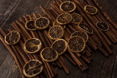 dried orange slices and cinnamon on wooden backgroundの写真素材