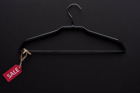 top view of hanger with sale label on black backgroundの写真素材