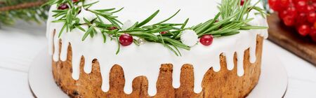 christmas pie with rosemary and viburnum berries on white wooden table with spruce branches