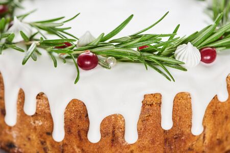 close up of sweet christmas pie with icing, rosemary and cranberries
