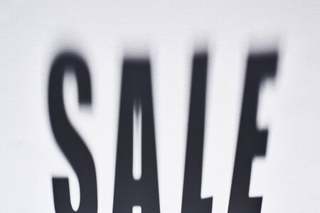 top view of shadow from sale lettering on white backgroundの写真素材