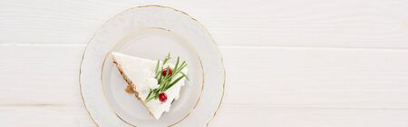 top view of piece of christmas pie on plate on white wooden table
