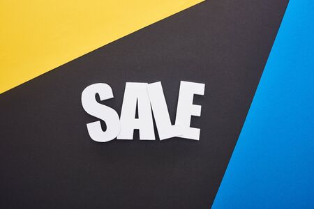 top view of sale lettering on blue, yellow and black backgroundの写真素材