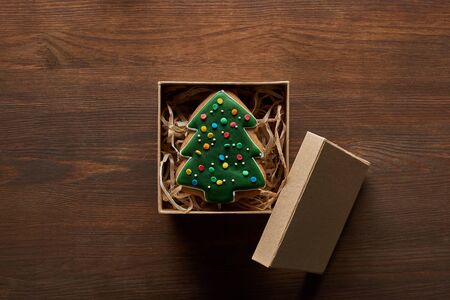 top view of Christmas tree cookie in gift box on wooden tableの写真素材