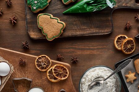 top view of Christmas cookies preparation on wooden table