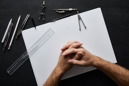 cropped view of man with clenched hands in office
