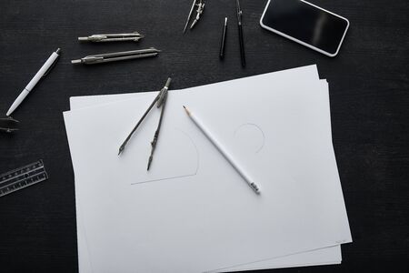 top view of papers, smartphone, pencil, pen, ruler and compassesの写真素材