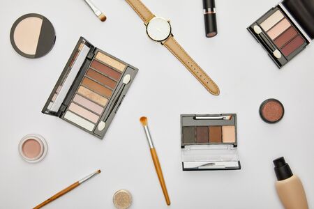 top view of watch near decorative cosmetics isolated on greyの写真素材