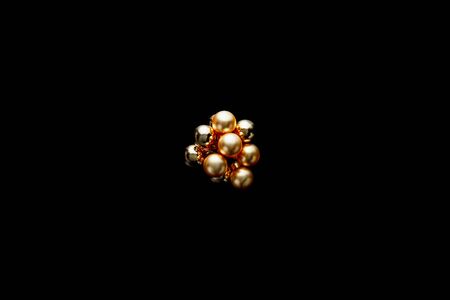 top view of shiny golden Christmas decoration isolated on blackの写真素材