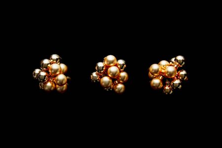 top view of shiny golden Christmas decoration isolated on black