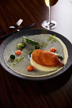 delicious chicken kiev and mashed potato served on plate on wooden tableの写真素材