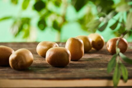 selective focus of ripe and whole kiwi on wooden surfaceの写真素材