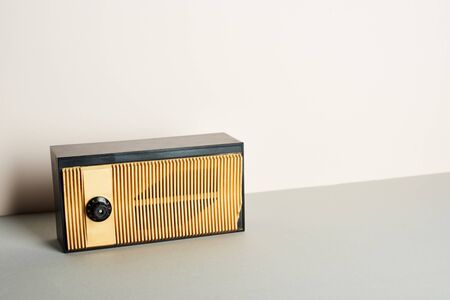 Retro radio on grey surface and white background