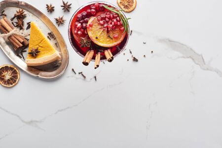 top view of christmas cocktails with orange, pomegranate, cinnamon and pie on trayの写真素材