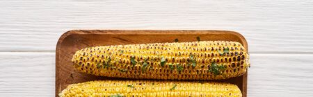 top view of grilled corn served at white wooden table for Thanksgiving dinner, panoramic shotの写真素材